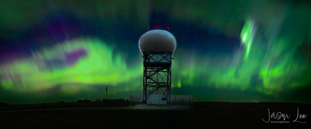 Enchanted Skies: Aurora Dance over Woodlands Radar