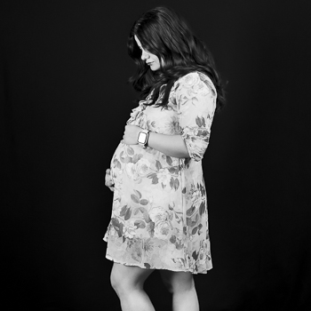 An elegant studio maternity portrait of a woman holding her baby bump in Jason Lee's Winnipeg photography studio. An elegant studio maternity portrait of a woman holding her baby bump in Jason Lee's Winnipeg photography studio.