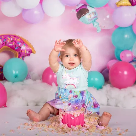 A one year old celebrating her cake smash in studio with Winnipeg Family Photographer Jason Lee A one year old celebrating her cake smash in studio with Winnipeg Family Photographer Jason Lee