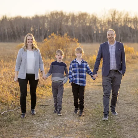 A family laughing and holding hands while walking during an Assiniboine Park Forest family session by Winnipeg Family Photographer Jason Lee A family laughing and holding hands while walking during an Assiniboine Park Forest family session by Winnipeg Family Photographer Jason Lee