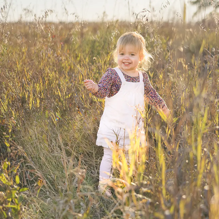 Toddler Girl in tall grass at Beaudry Provincial Park during a Fall Family Session