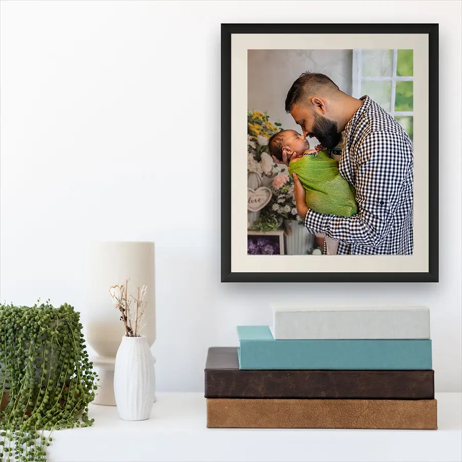 A close-up of a handcrafted leather heirloom photo album and museum-quality fine art prints by Winnipeg photographer Jason Lee.