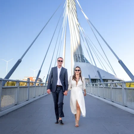 A bride and groom sharing a moment on the iconic Esplanade Riel pedestrian bridge in Winnipeg A bride and groom sharing a moment on the iconic Esplanade Riel pedestrian bridge in Winnipeg