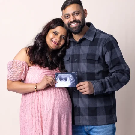 A timeless studio maternity portrait of a woman and her partner holding an ultrasound photo in Jason Lee's Winnipeg photography studio. A timeless studio maternity portrait of a woman and her partner holding an ultrasound photo in Jason Lee's Winnipeg photography studio.