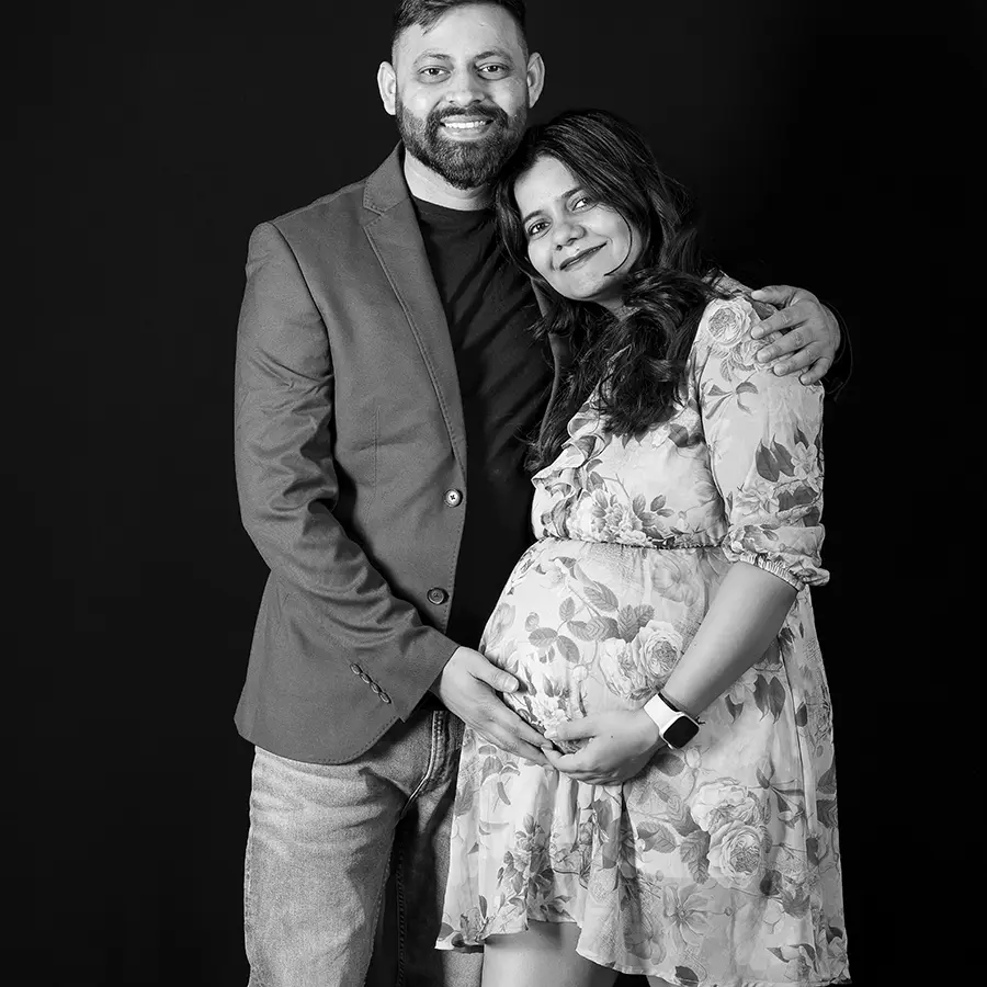 An Elegant studio maternity portrait of a woman and her partner in Jason Lee's Winnipeg photography studio.