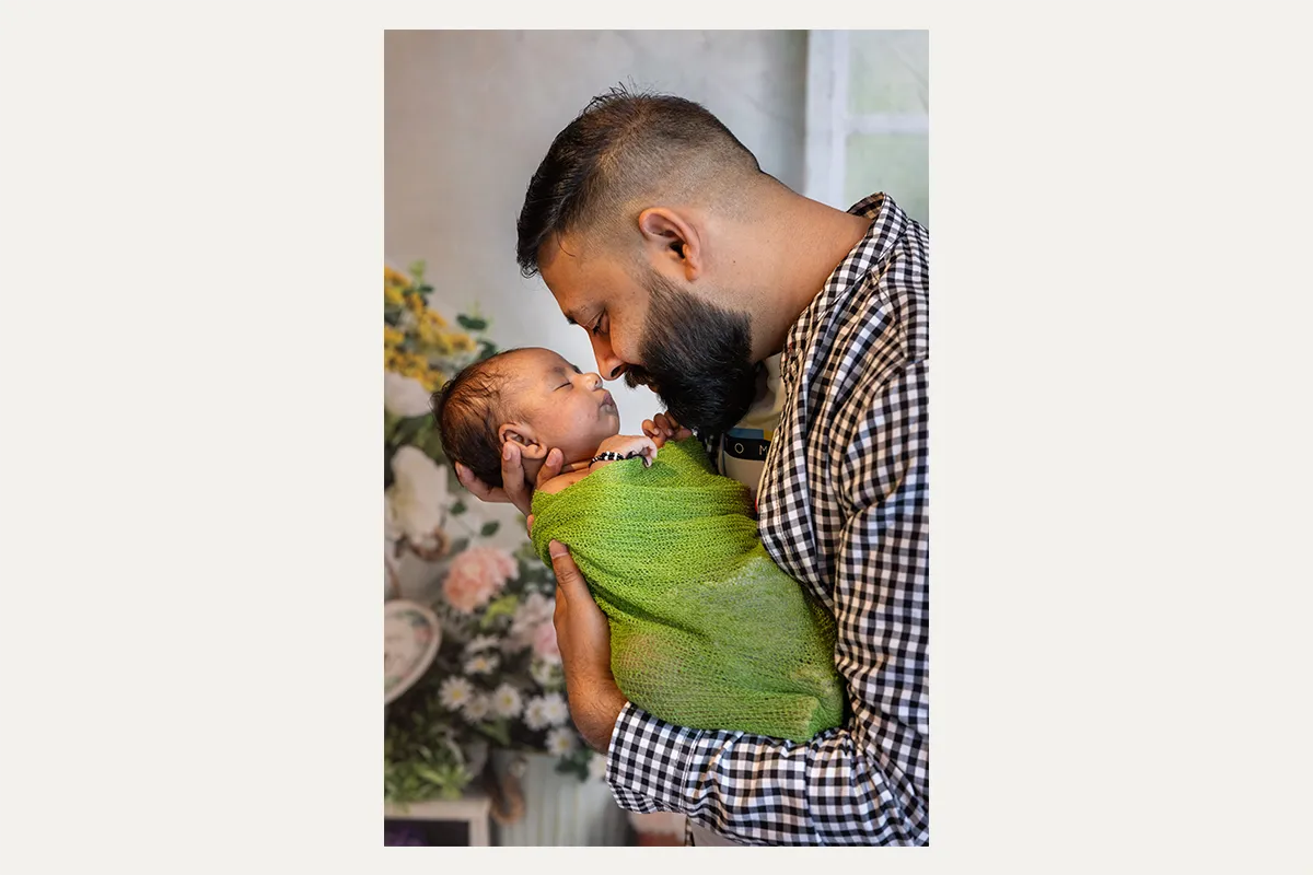 Father holding his newborn baby during a Winnipeg newborn photography session