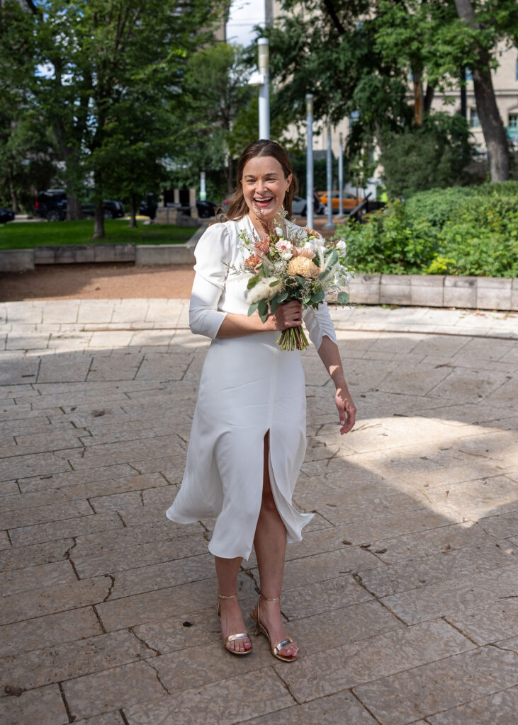 Bride holding her wedding bouquet near Upper Fort Garry in Winnipeg