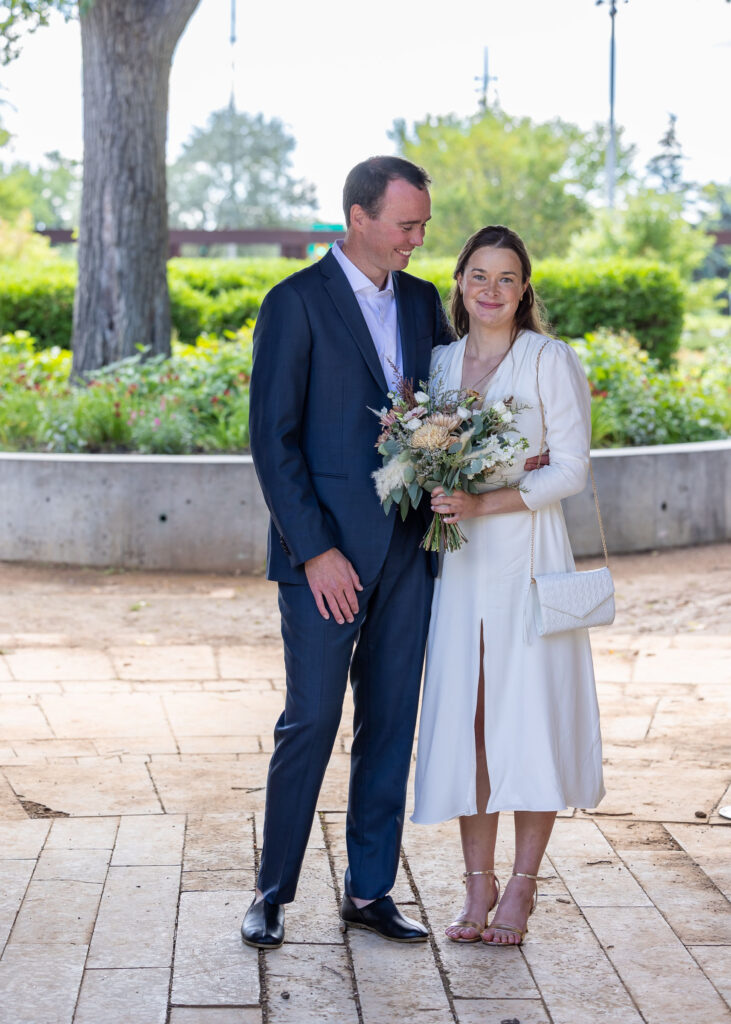 Bride and groom together with a wedding bouquet near Upper Fort Garry