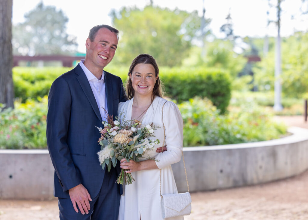 Bride and groom together with a wedding bouquet near Upper Fort Garry
