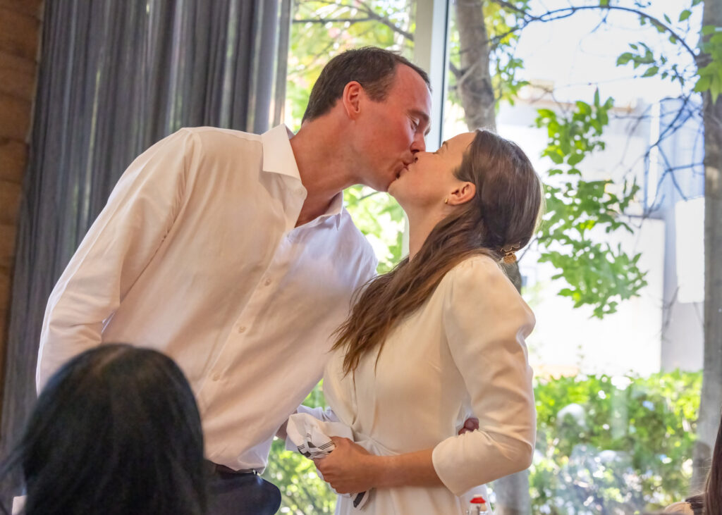 Newlyweds sharing a kiss during their wedding reception at Inn at the Forks