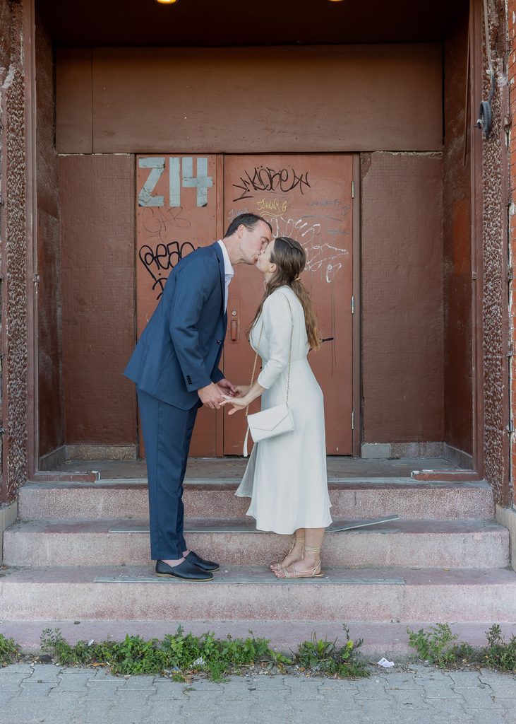 Newlyweds kissing during evening wedding portraits in downtown Winnipeg