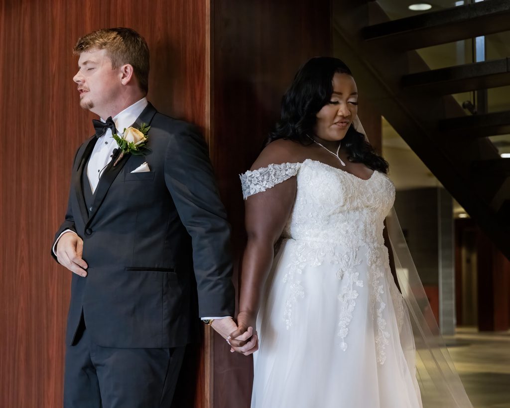Bride and groom holding hands during a quiet prayer before their wedding ceremony at the Viscount Gort Hotel