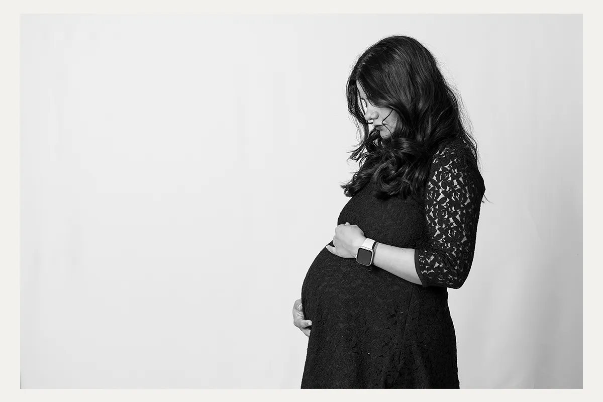 Black and white studio maternity portrait of an expectant mother