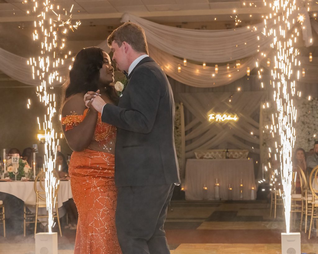 Newlyweds dancing between indoor sparklers at their Viscount Gort Hotel wedding reception