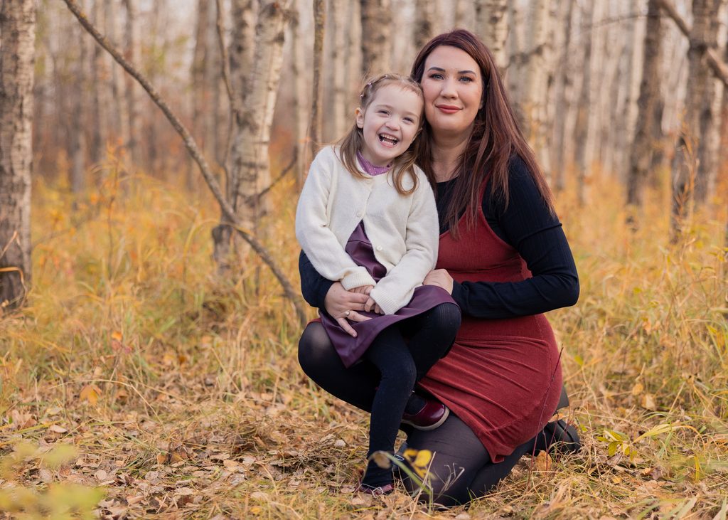 Mother and daughter sharing a laugh during their fall family photography session