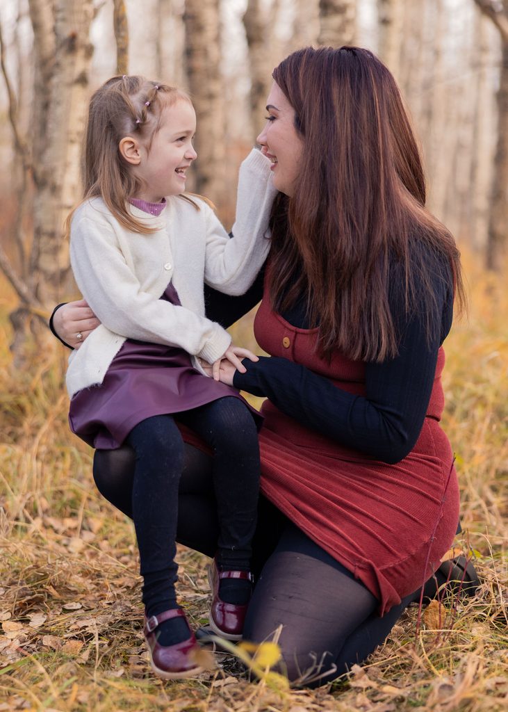Mother and daughter sharing a quiet moment together during their autumn portrait session