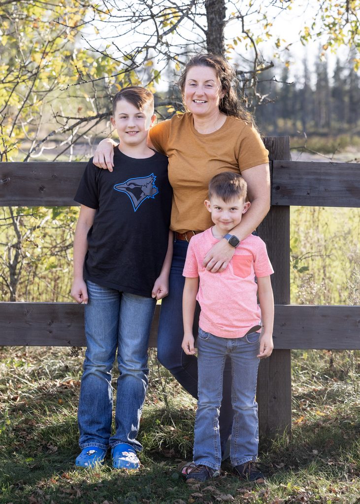 Mother with her two sons during an outdoor family portrait session in the Whiteshell
