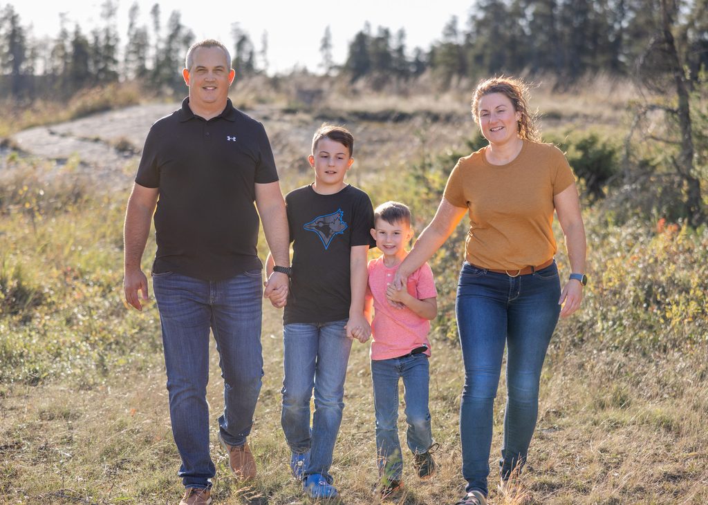 Family walking together through the autumn landscape at Alf Hole Goose Sanctuary in Whiteshell Provincial Park