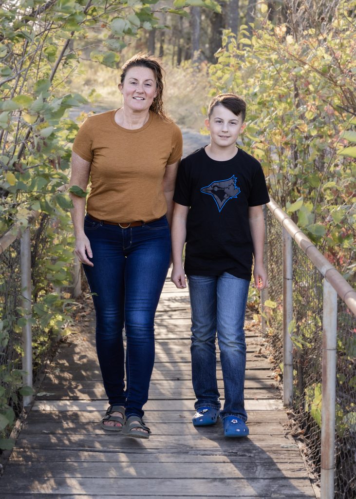 Mother and son walking together across a footbridge at Alf Hole Goose Sanctuary