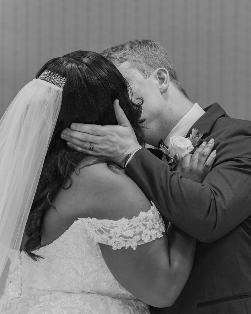 Newlyweds sharing a kiss during their Viscount Gort Hotel wedding ceremony