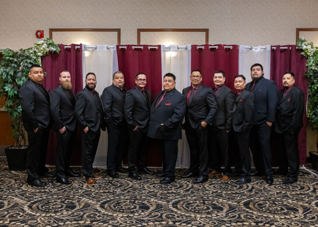 Groom and groomsmen in dark suits at the Victoria Inn in Winnipeg