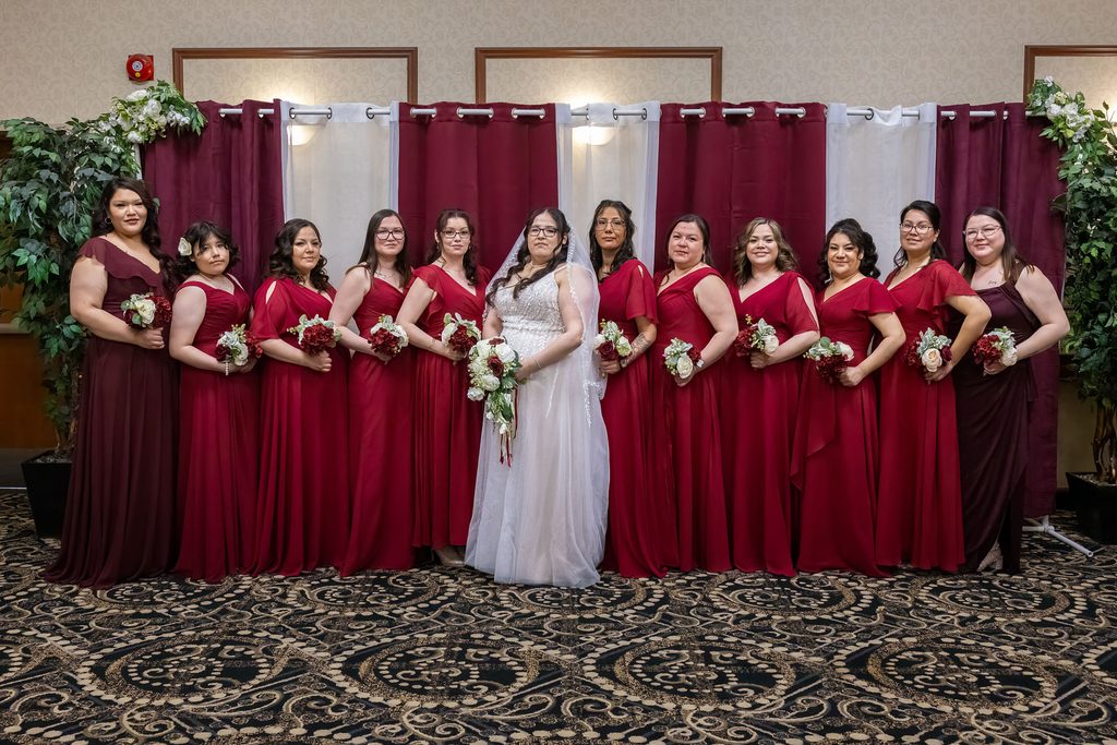 Bride with bridesmaids in burgundy dresses at the Victoria Inn in Winnipeg