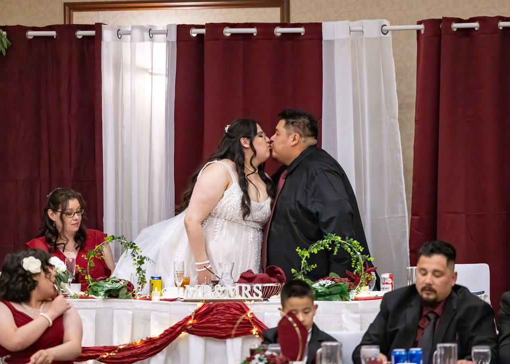 Bride and groom sharing a kiss during their Victoria Inn wedding reception