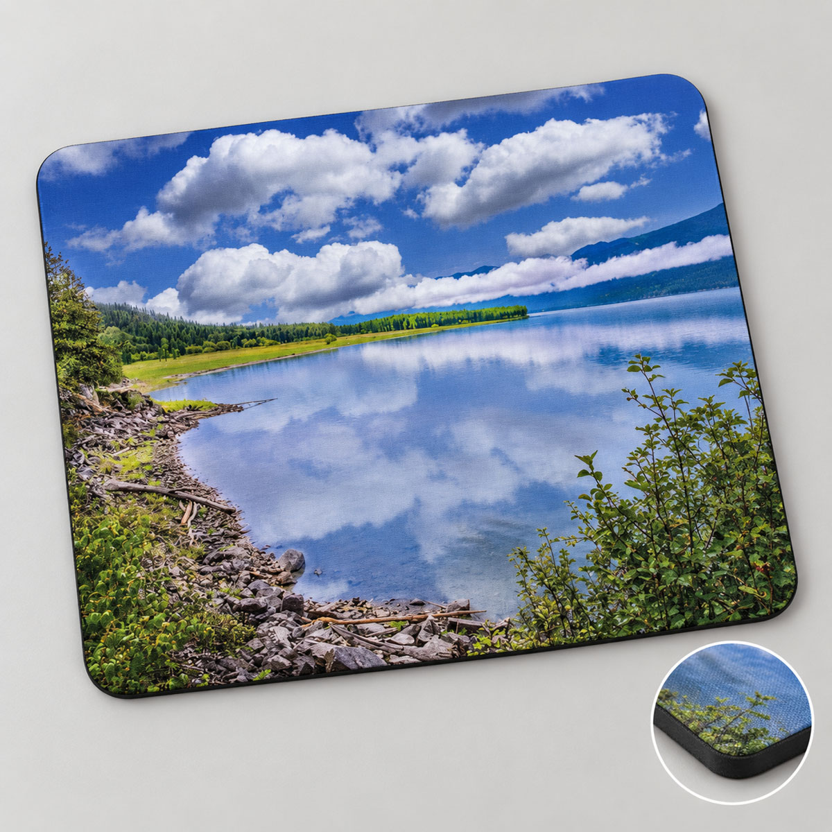Photo mousepad featuring clouds reflected in Kootenay Lake beside a rocky shore, with an inset showing its edge.