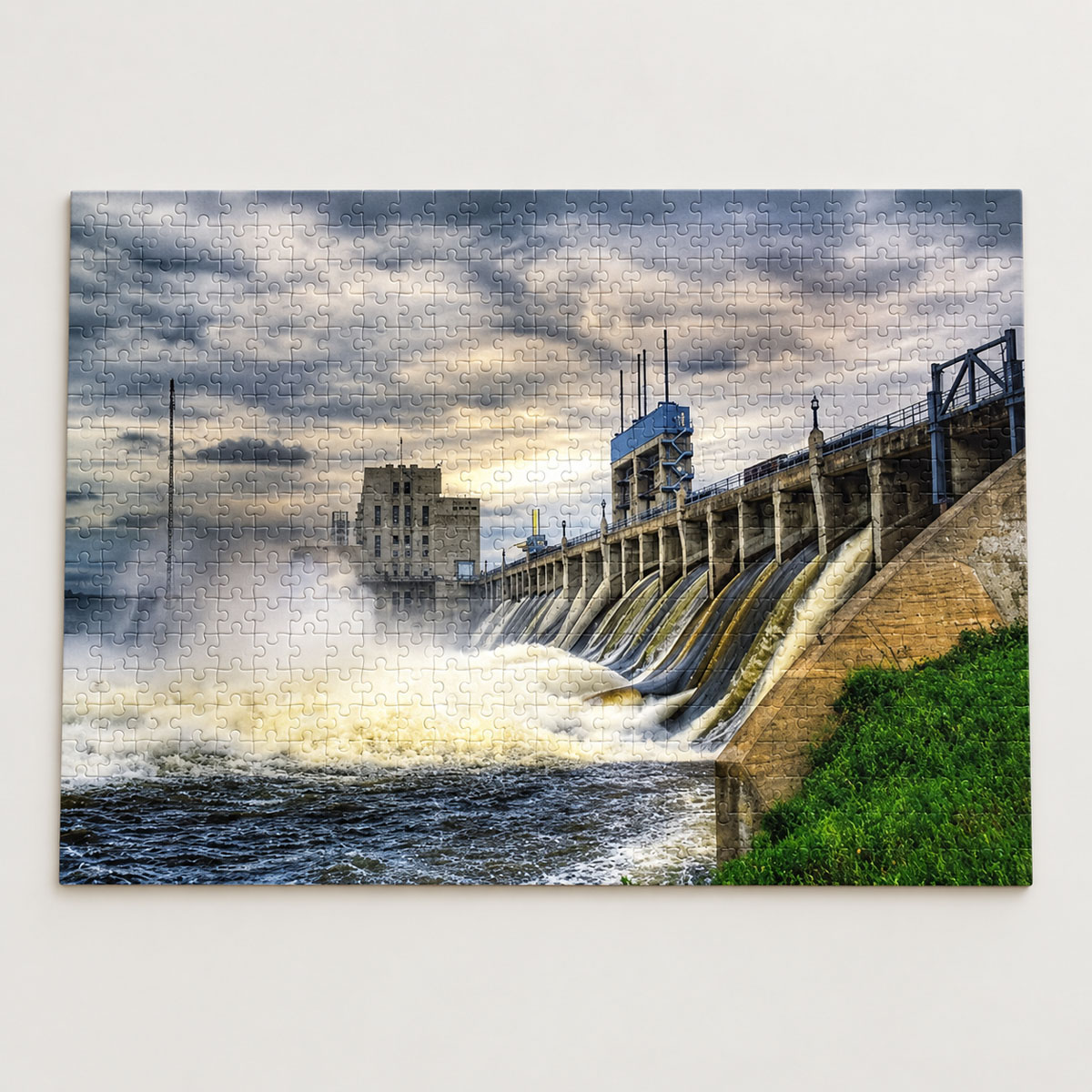 500-piece jigsaw puzzle featuring water flowing through the Seven Sisters Falls hydroelectric dam beneath a cloudy sky.