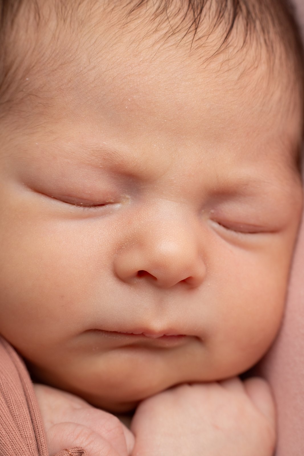 Close-up portrait of a sleeping newborn baby.