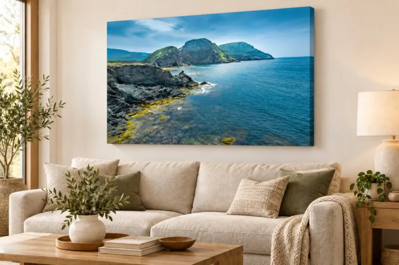 Sea Cave at Bottle Cove canvas displayed above a sofa in an illustrative living-room mockup